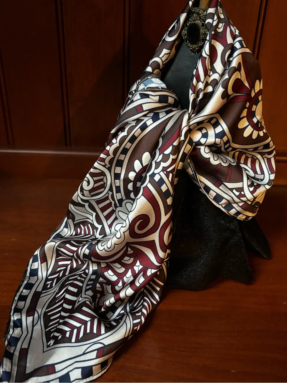 elegant brown, white, and burgundy silk scarf features an ornate floral